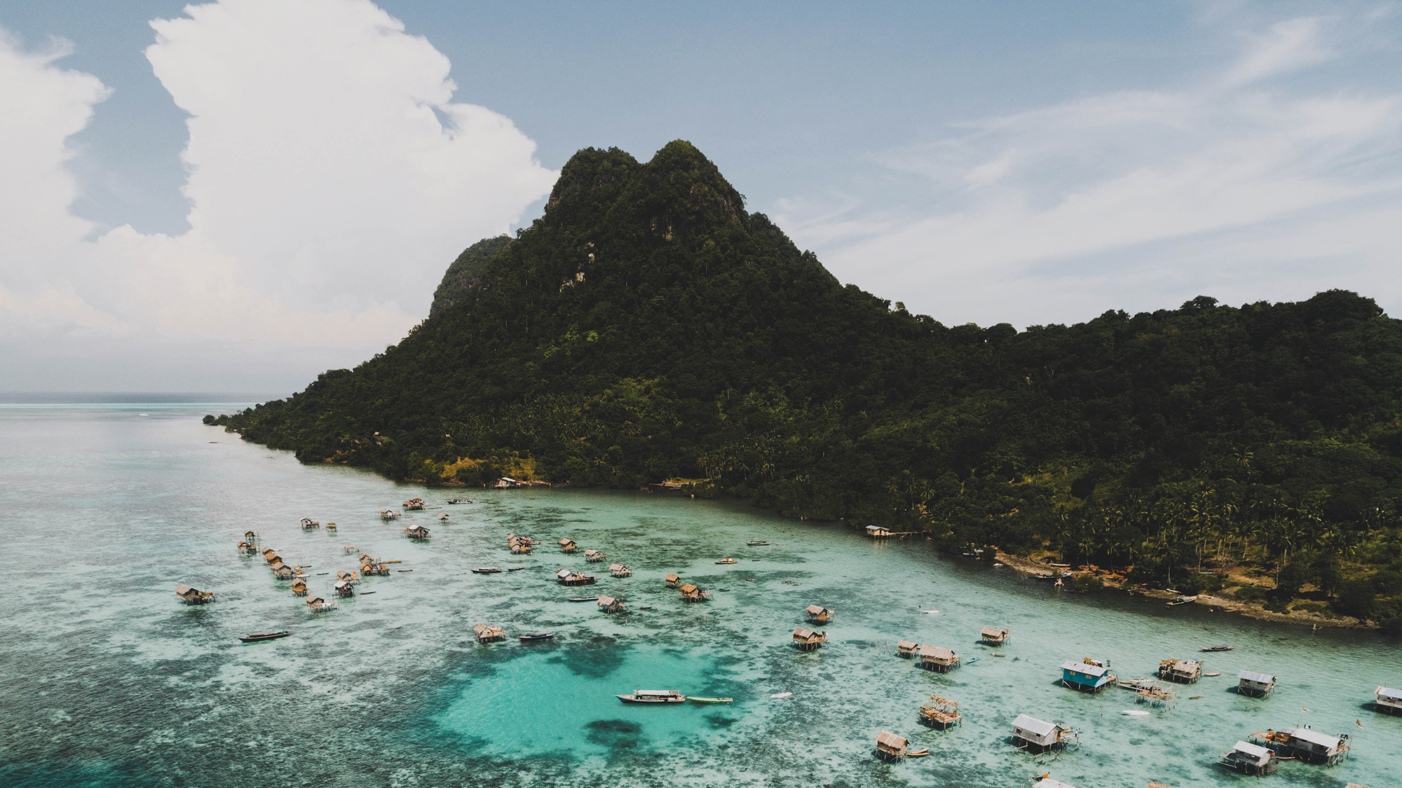 Aerial view of stilt village in turquoise water off the Malaysian coast