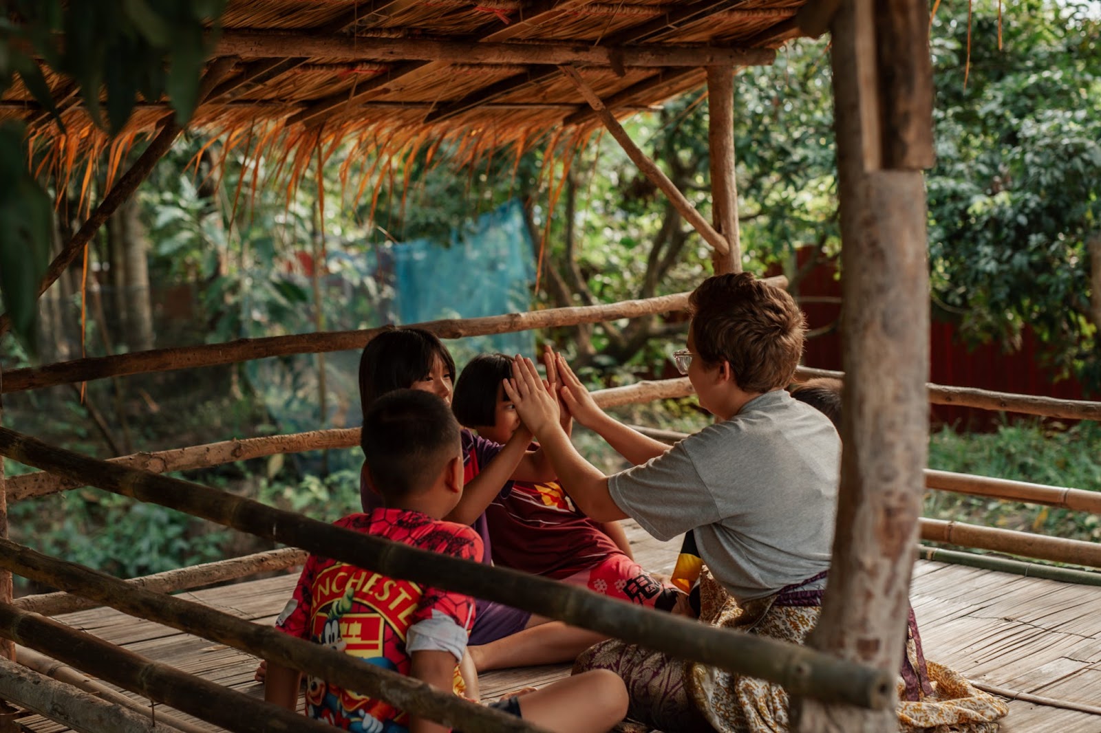 Squad member playing with kids in a Thai village
