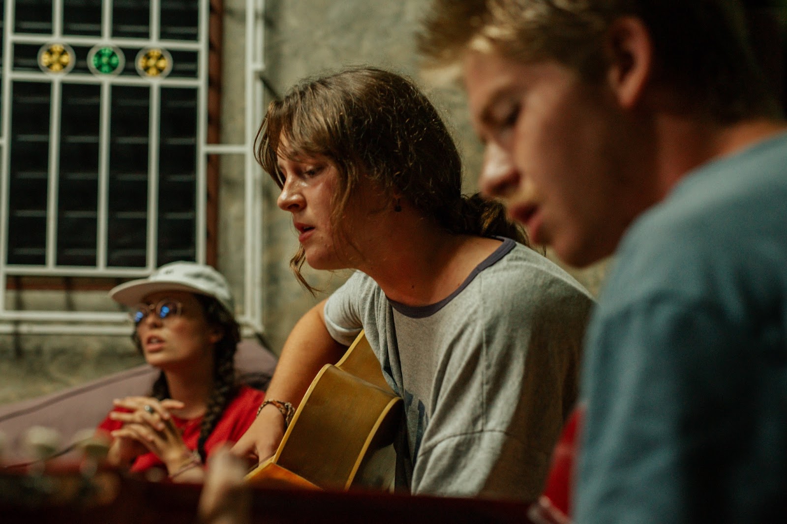 Squad worshiping together with guitar