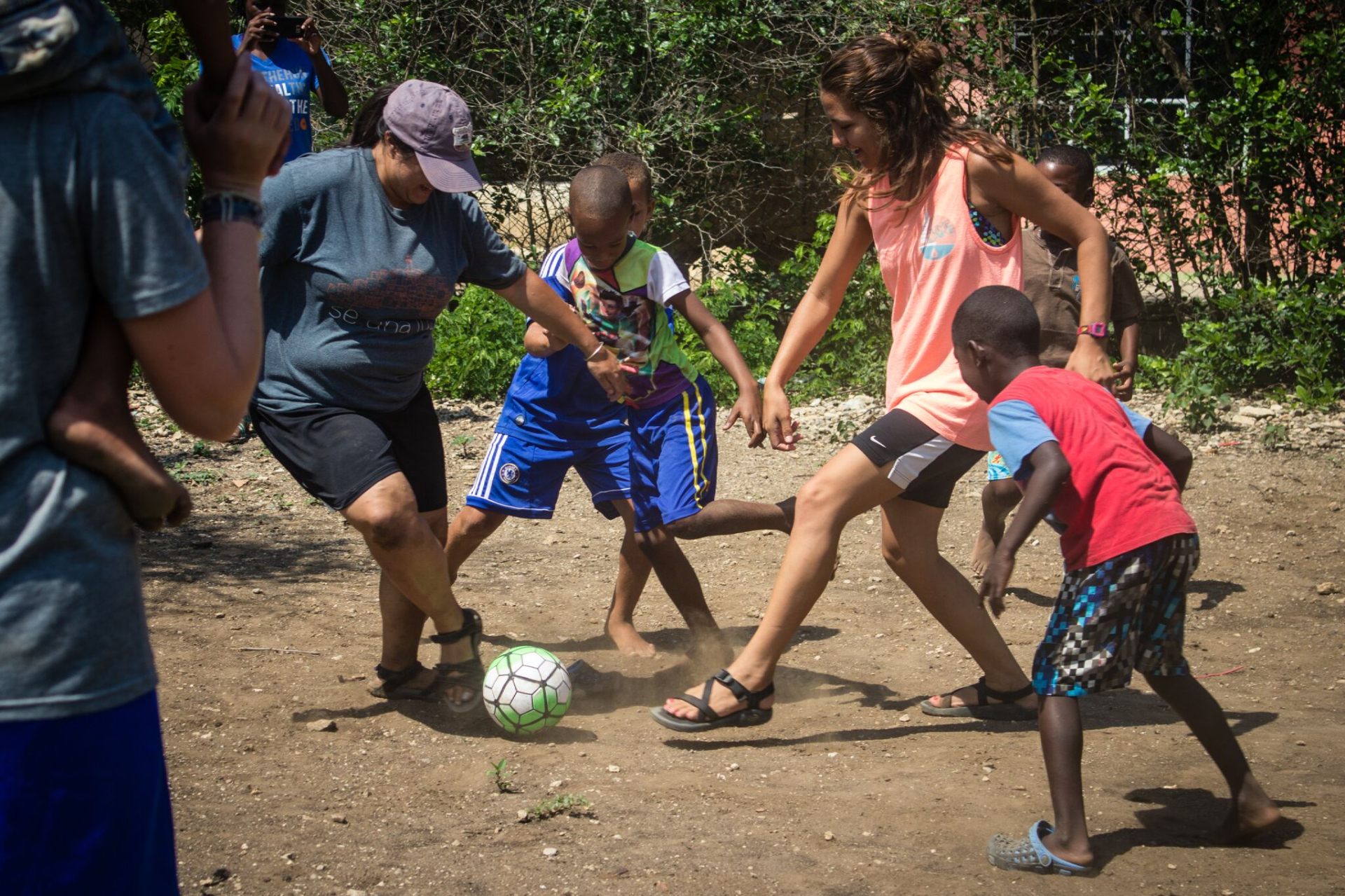 Squad members playing soccer with children in Colombia